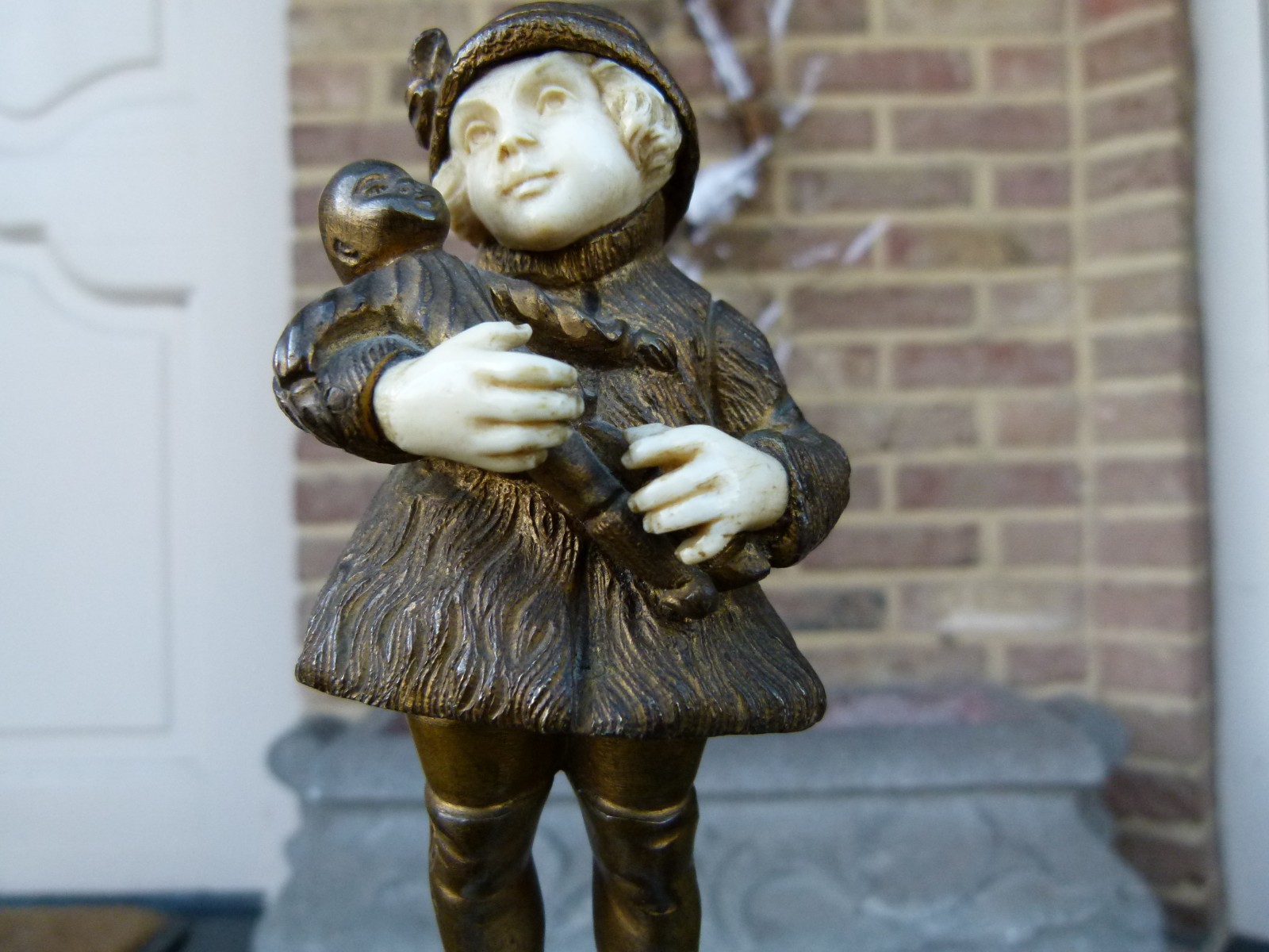 sculpture by G.Omert child with doll